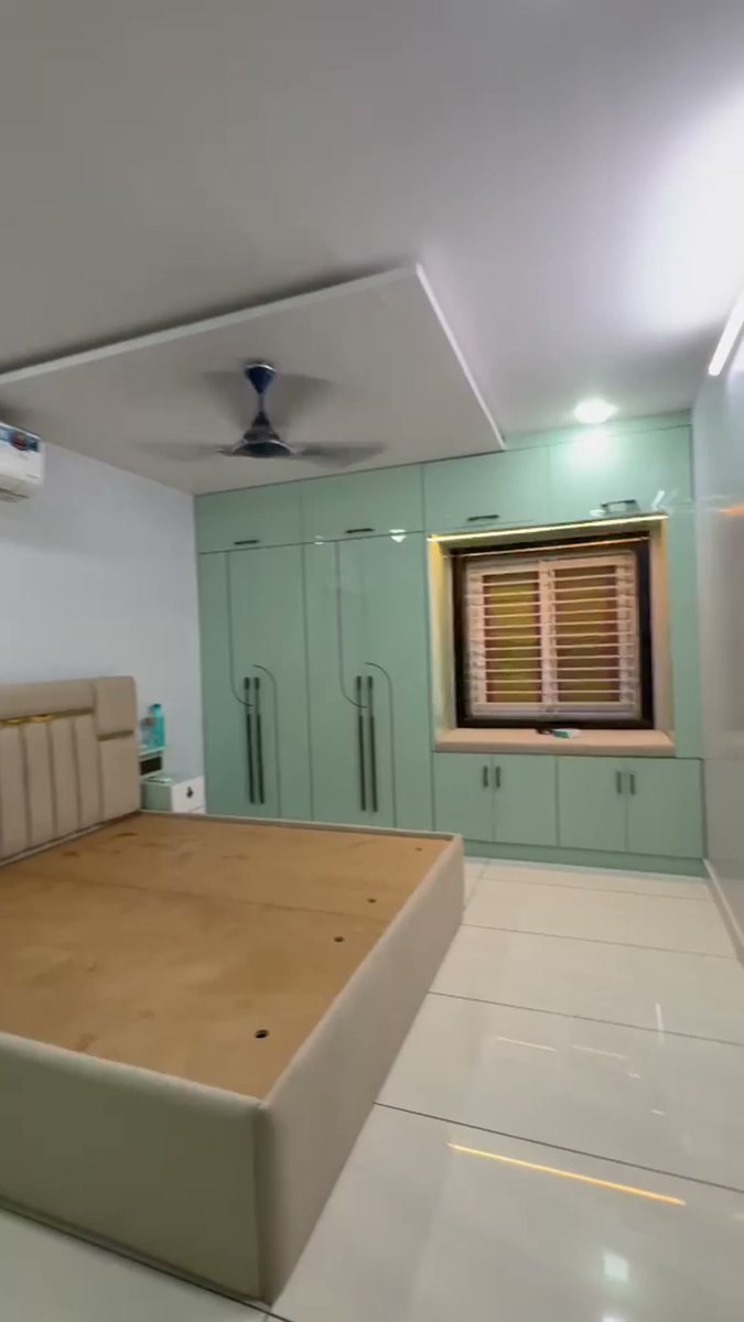Mint green wardrobes with a lit window bay