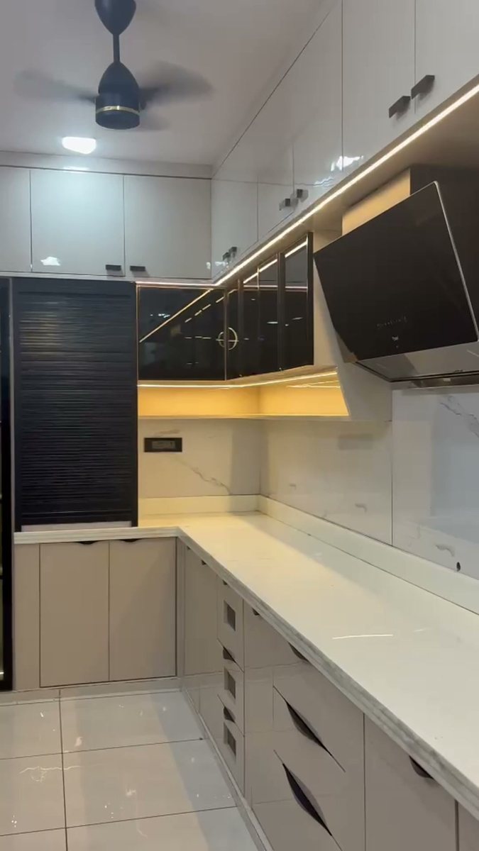 Kitchen uppers with under-cabinet strip lighting and a tall roller shutter