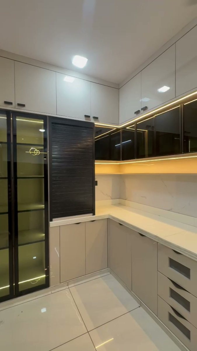 Glass-front storage tower with lit shelves