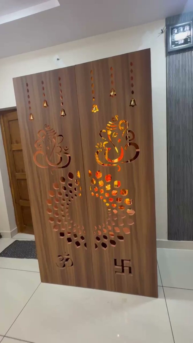 CNC-cut Ganesha door glowing from backlight